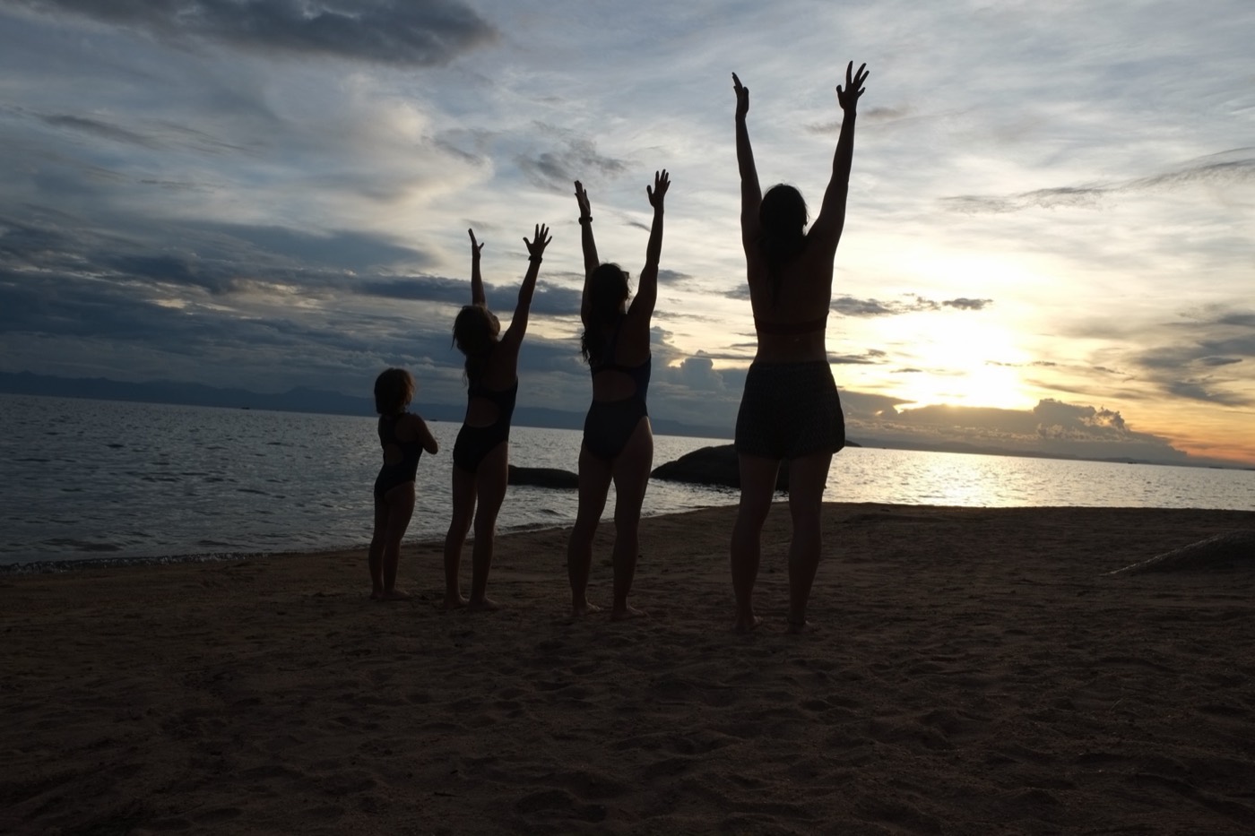 Family yoga at sunset